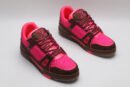 A single pink and brown Louis Vuitton LV Trainer sneaker, covered in glittering pink crystal embellishments, with "VUITTON" visible on the side strap