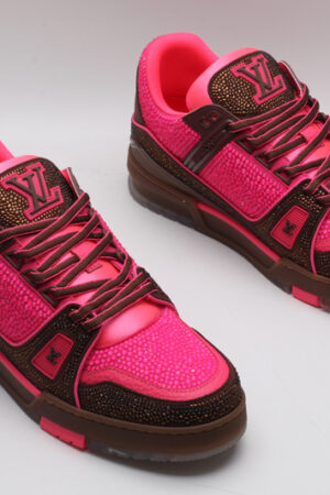 A single pink and brown Louis Vuitton LV Trainer sneaker, covered in glittering pink crystal embellishments, with "VUITTON" visible on the side strap