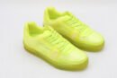 A pair of vibrant neon yellow/lime green translucent low-top sneakers with matching laces and a thick, clear-infused sole, set against a simple white background.