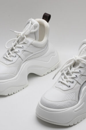 A pair of white Louis Vuitton LV Archlight chunky sneakers, showcasing their distinctive wave-shaped outsole, leather and technical fabric upper, and subtle monogram details.