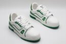 A single white and green Louis Vuitton LV Trainer sneaker, covered in glittering green crystal embellishments, with "VUITTON" visible on the outsole.