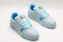 A single light blue Louis Vuitton LV Trainer Low-Top Sneaker, showcasing its embossed monogram on light blue leather, light blue and darker blue accents, and white sole.