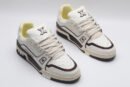 A single white Louis Vuitton LV Trainer Low-Top Sneaker, showcasing its embossed monogram on white leather and brown accents.