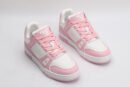 A pair of white and pink Louis Vuitton LV Trainer Low-Top Sneakers, with the right shoe displayed with its sole facing up, showcasing the white and pink outsole with "VUITTON" branding.
