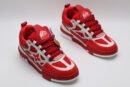 A single red and white Louis Vuitton LV Trainer sneaker, showcasing its vibrant color blocking, mesh panels, and robust sole.