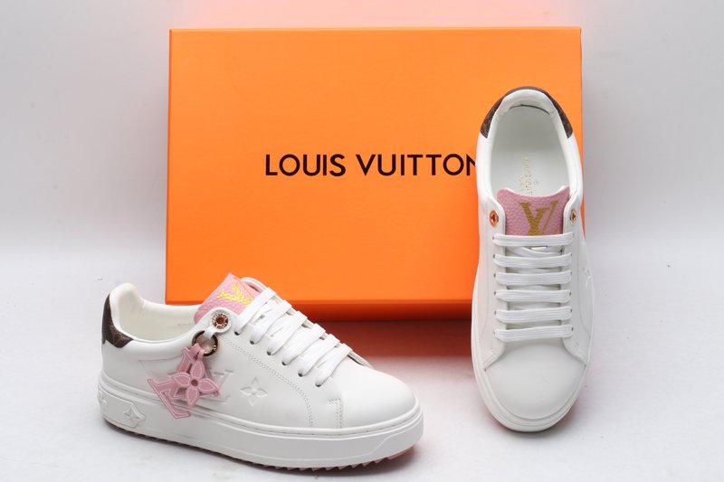 A top-down view of a pair of white Louis Vuitton Stellar Low-Top Sneakers, featuring pink tongues with gold LV logos and brown monogrammed heel tabs.