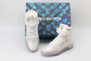 A pair of transparent white Louis Vuitton LV Trainer high-top sneakers with clear velcro straps and a chunky white sole