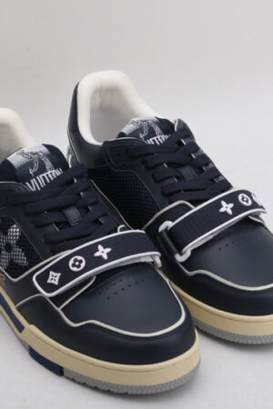 "A pair of OceanDepth Navy and White Urban Sneakers, viewed from the top, showcasing their low-top design, white laces, deep navy leather, white piping, mesh panels, and distinctive strap across the vamp."