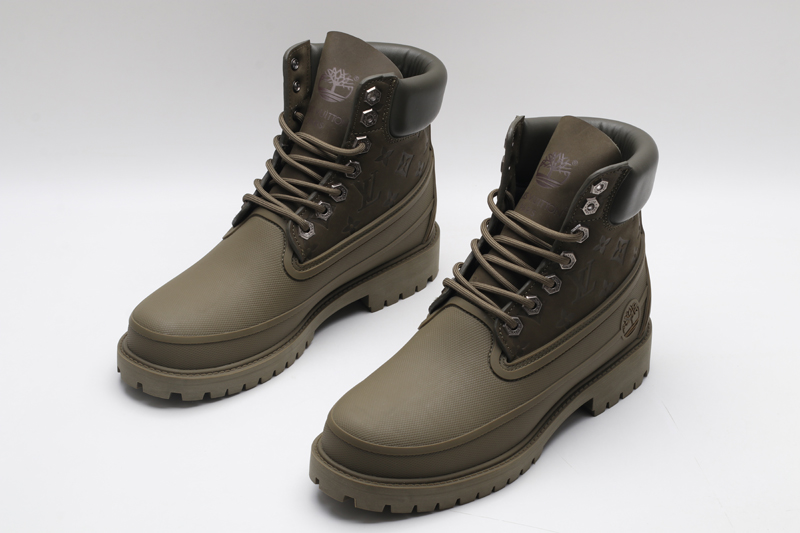 A pair of olive green Timberland x Louis Vuitton collaborative waterproof boots, featuring the Timberland tree logo and subtle Louis Vuitton monogram debossing on the upper.