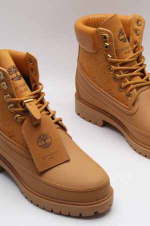 A single classic tan Timberland x Louis Vuitton collaborative waterproof boot, featuring the Timberland tree logo and subtle Louis Vuitton monogram debossing on the side.