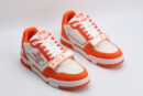 "A pair of Vibrant Horizon Orange and White Sneakers, viewed from an angle, showcasing their low-top design, white laces, orange suede accents, white leather panels, and distinctive strap across the vamp