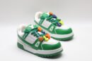 A single white and green Louis Vuitton LV Trainer Low-Top Sneaker, showcasing its full design from a slight angle, with bright orange and purple lace accents.