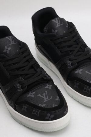 A pair of Louis Vuitton LV Trainer sneakers in black and grey monogram, featuring a white midsole and translucent outsole