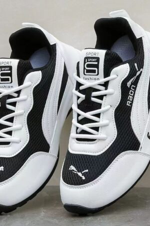 A pair of black and white unisex running shoes with a breathable mesh upper and a flexible, cushioned soft sole.