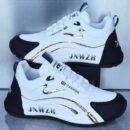 A pair of unisex casual sneakers with a white base, an athletic design, and a shiny gold stripe on the side.