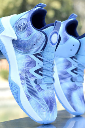 A pair of unisex athletic basketball shoes in blue and white with a dynamic graphic pattern and a thick, supportive sole.