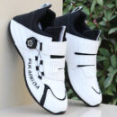 A pair of white and red unisex performance sneakers with a dial lacing system and a velcro strap.