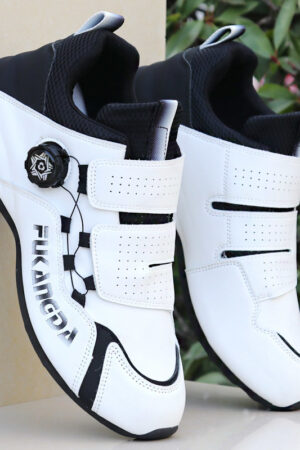 A pair of white and red unisex performance sneakers with a dial lacing system and a velcro strap.