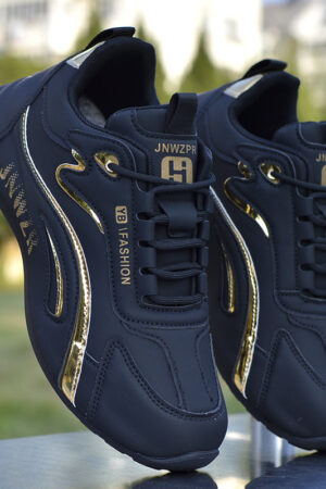 A pair of black, gray, white, and red unisex fashion sneakers with a multi-paneled upper and a chunky, sculpted sole.