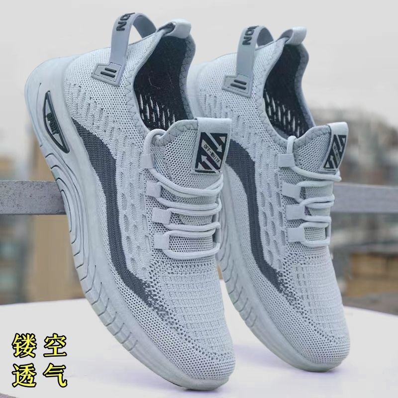 A pair of black and white unisex athletic shoes with a breathable mesh upper and a thick, segmented sole.