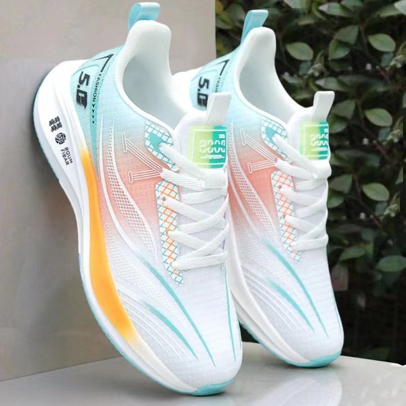 A pair of high-performance unisex running shoes with a thick, cushioned sole, available in white with orange and blue accents.