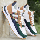 A pair of unisex casual sneakers in black and white with a thick, ridged sole and a minimalist design.