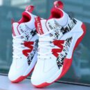 A pair of high-top unisex athletic sneakers in white and black with urban graphic patterns and a red sole.