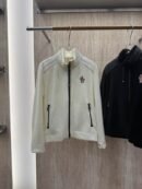 A Moncler Grenoble fleece zip-up cardigan, dark color, with the Moncler logo patch visible on the chest.