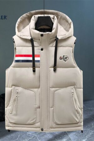 hooded puffer vest with horizontal quilting, featuring a full snap-button front, two zippered pockets, and a rectangular tri-color stripe patch on the left chest.