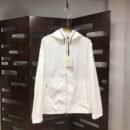 Crisp white lightweight windbreaker jacket with tricolor trim on the hood and a small logo on the sleeve.