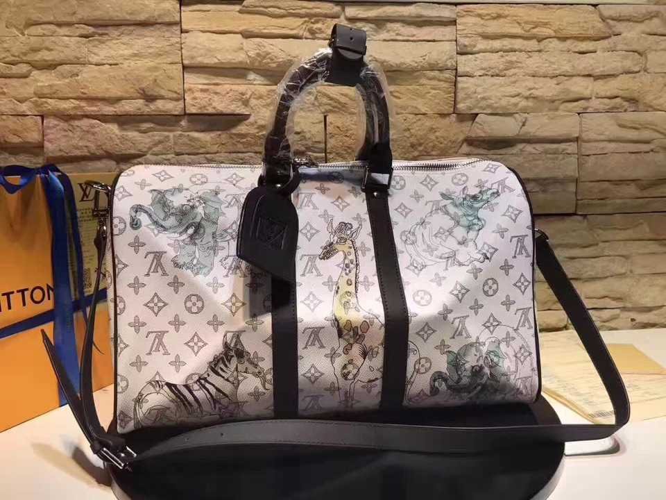 A high-quality Louis Vuitton inspired Chapman Brothers Keepall bag in white Monogram Savane canvas with light blue animal sketches and black handles.