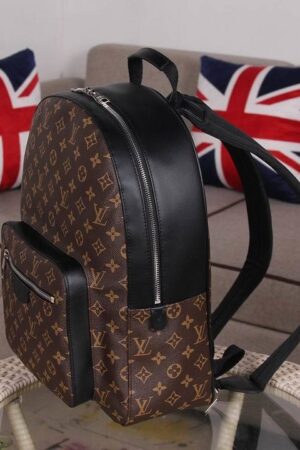 A high-quality Louis Vuitton inspired Josh backpack in brown monogram canvas with a black leather front pocket and top handle.