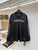 Black long-sleeve mesh jersey with Gothic Chrome lettering on the chest and floral vine patterns on the sleeves hanging on a rack.
