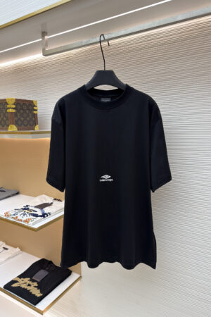 A black short-sleeve T-shirt featuring a small white Balenciaga 3B Sports logo centered on the chest.