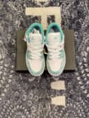 Top-down view of Air Jordan 1 Low SE sneakers with white leather and distressed emerald green overlays.