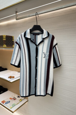 A premium men's short sleeve utility shirt featuring two chest pockets and a designer logo patch on the sleeve, shown in black and khaki versions.