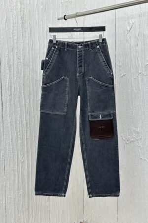 Dark gray wide-leg denim carpenter pants with white contrast stitching and a utility pocket detail on the leg.