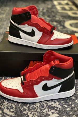 A pair of high-top sneakers with red and white leather, black snakeskin texture on the heel, and a white midsole.