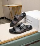 Pair of luxury Berluti Sifnos double-strap buckle sandals in black and grey smoky leather with Scritto calligraphy engraving.