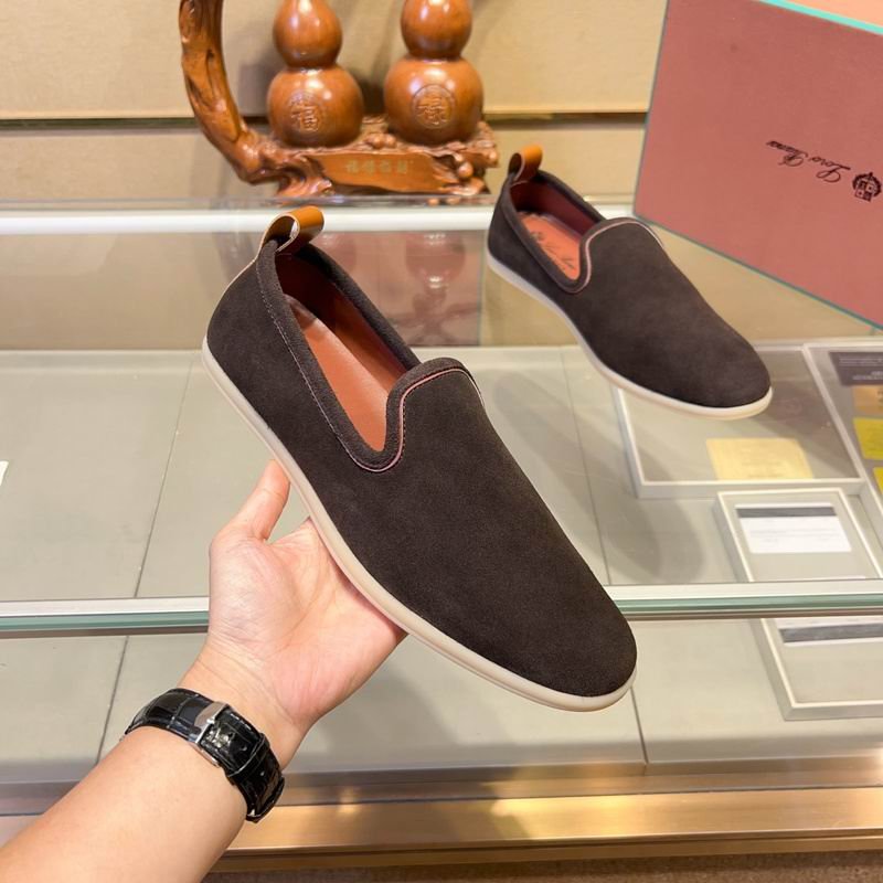 Pair of chocolate brown suede Loro Piana 360 LP Flexy Walk sneakers with brown leather heel tabs displayed on a glass shelf.