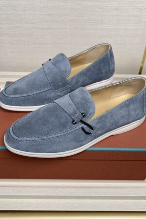 Steel blue suede Loro Piana Summer Walk loafers with charms and white rubber soles displayed on a brown designer box.
