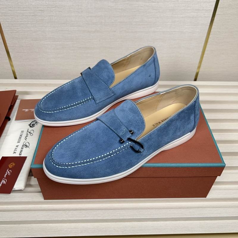 Sky blue suede Loro Piana Summer Walk loafers with charms and white stitching resting on a brown designer box.