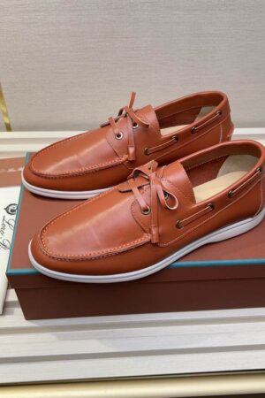 A pair of smooth cedar brown leather Summer Walk boat shoes with white rubber soles and matching leather laces, displayed on an orange branded box.